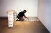 View of the artist installing the work  for Felix Gonzalez-Torres ; Untitled (Placebo) 1991