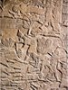 Teumman is caught and decapitated by an Assyrian soldier; Limestone panel in the Southwest Palace of Ashurbanipal