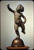 Putto poised on a Globe