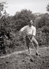 Wassily Kandinsky spading the garden at the Murnau house