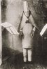 Hugo Ball in "cubist costume" reciting his poem 'Elefantenkarawane" at the Cabaret Voltaire, Zurich; 23 June 1916